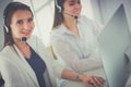 Smiling businesswoman or helpline operator with headset and computer at office Royalty Free Stock Photo