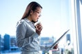 Smiling businesswoman holding disposable cup reading newspaper Royalty Free Stock Photo