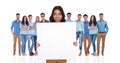 Smiling businesswoman holding empty board in front of her group Royalty Free Stock Photo