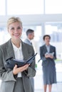 Smiling businesswoman holding files and looking at camera Royalty Free Stock Photo