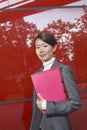 Smiling Businesswoman Holding Folder Royalty Free Stock Photo