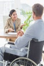 Smiling businesswoman interviewing disabled candidate