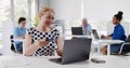 Smiling businesswoman with laptop and credit card working in office Royalty Free Stock Photo