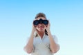 Smiling businesswoman looking through binoculars Royalty Free Stock Photo