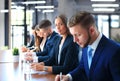 Smiling businesswoman looking at camera at seminar with her colleagues near by Royalty Free Stock Photo