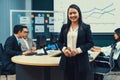 Smiling businesswoman looking at camera while standing at meeting. Intellectual. Royalty Free Stock Photo