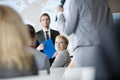 Smiling businesswoman looking colleague speaking during seminar Royalty Free Stock Photo