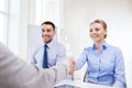 Smiling businesswoman making handshake in office Royalty Free Stock Photo