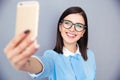 Smiling businesswoman making selfie photo