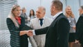 smiling businesswoman meeting colleagues with a handshake. Royalty Free Stock Photo