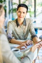 Smiling Businesswoman Meeting Partners in Cafe Royalty Free Stock Photo