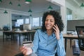 Smiling businesswoman ordering something using her cellphone and credit card