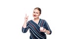 smiling businesswoman with pink piggy bank doing idea gesture