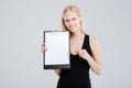 Smiling businesswoman pointing at blank clipboard Royalty Free Stock Photo