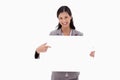 Smiling businesswoman pointing at blank sign board Royalty Free Stock Photo