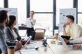 Smiling businesswoman pointing near blurred colleagues Royalty Free Stock Photo