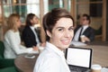 Smiling businesswoman professional interpreter looking at camera