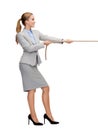 Smiling businesswoman pulling rope