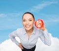 Smiling businesswoman with red clock Royalty Free Stock Photo