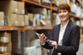 Smiling businesswoman scrolling on digital tablet