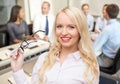 Smiling businesswoman or secretary in office Royalty Free Stock Photo