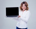 Smiling businesswoman showing laptop screen Royalty Free Stock Photo