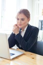 Smiling businesswoman sitting at her desk working on laptop Royalty Free Stock Photo