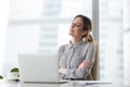 Smiling female boss relaxing in office chair with eyes closed Royalty Free Stock Photo