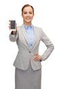 Smiling businesswoman with smartphone blank screen