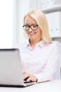 Smiling businesswoman or student with laptop Royalty Free Stock Photo