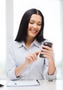 Smiling businesswoman or student with smartphone Royalty Free Stock Photo