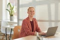 Smiling Businesswoman in Sunlit Office Royalty Free Stock Photo