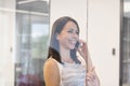 Smiling businesswoman talking on mobile phone at office Royalty Free Stock Photo