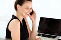 Smiling businesswoman talking on mobile phone in a office Royalty Free Stock Photo