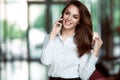 Smiling businesswoman talking on the phone at the office.
