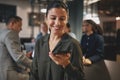 Smiling businesswoman talking on speakerphone while working in a