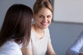 Smiling businesswoman talking to colleague at office meeting or Royalty Free Stock Photo