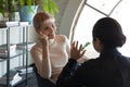 Smiling businesswoman talking to diverse colleague in modern office