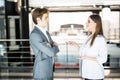 Smiling businesswoman telling something to her colleague in the office. Business man speak with business woman in office Royalty Free Stock Photo