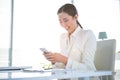 Smiling businesswoman texting on her phone Royalty Free Stock Photo