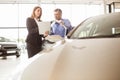 Smiling businesswoman undersign a car contract