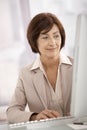 Smiling businesswoman using computer