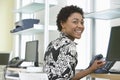 Smiling Businesswoman Using Computer In Office