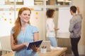 Smiling businesswoman using digital tablet with colleagues Royalty Free Stock Photo