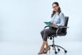 smiling businesswoman using digital tablet while sitting in office chair Royalty Free Stock Photo