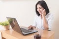 Smiling businesswoman using mobile phone at desk. Beautiful young secretary talking on the phone at office. Success business. Royalty Free Stock Photo