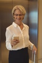 Smiling businesswoman using smart phone Royalty Free Stock Photo