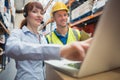 Smiling businesswoman wearing headset using laptop Royalty Free Stock Photo