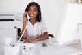 Smiling businesswoman in wheelchair working at her desk Royalty Free Stock Photo