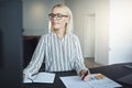 Smiling businesswoman working at her desk in a bright office Royalty Free Stock Photo